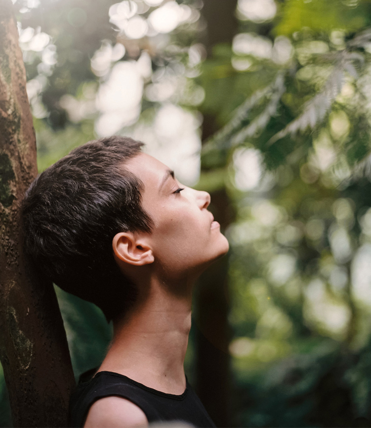 woman meditating in forest for better mental health
